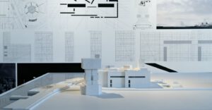 Architectural building model displayed in front of technical drawings